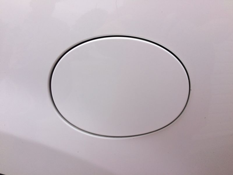 Sticker on the fuel door. Warmed up with a heat gun and pealed it off, then dhesive remover to clean up any residue, then a liquied clay bar, and finished off with some wax.