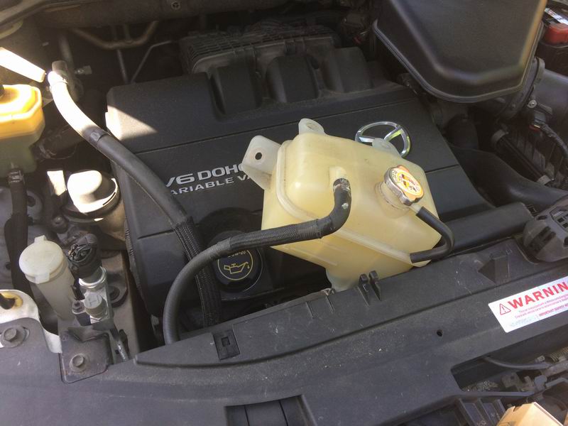 Right side: remove the 3 10mm bolts and move the coolant overflow tank out of the way.