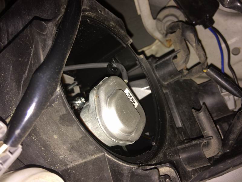 Left side: the low beam housing is right next to the fender. Twist off the weather cap, twist off the electrical connector, unclip the two bulb retainer arms (push in each arm so it can move outwards), pivot the retainer downwards and pull the bulb out.