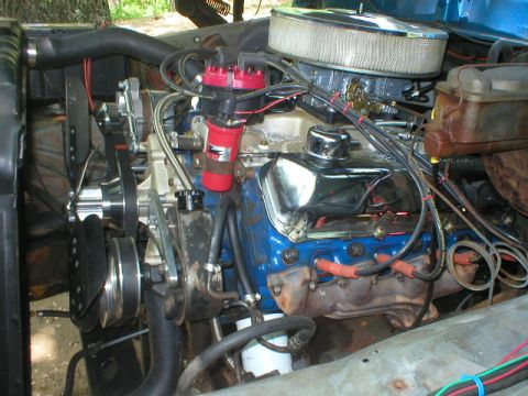 1978 Ford Bronco - Close view of a blue-block V8 in a truck engine bay, topped with a chrome-lidded air cleaner over a four-barrel carburetor and a red distri…