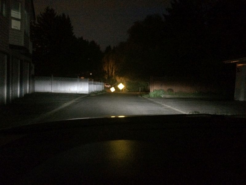 Interior view of a 2009 Mazda CX-9 at night, headlights on, illuminating a street.