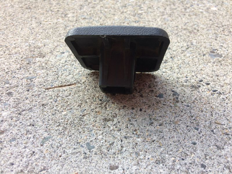 Black plastic part with textured surface on concrete