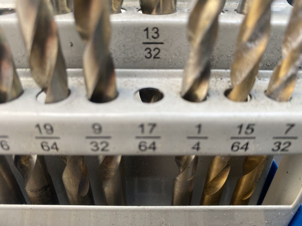Drill bits in a holder with fractional measurements