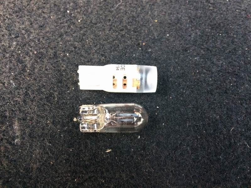 Clear glass incandescent bulb and a white LED bulb.