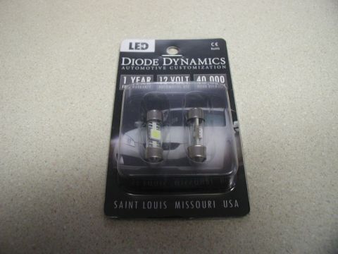 2009 Mazda CX-9 - A package containing two automotive bulbs, one LED and one incandescent, from Diode Dynamics. The packaging indicates 1 year warranty, 12 v…
