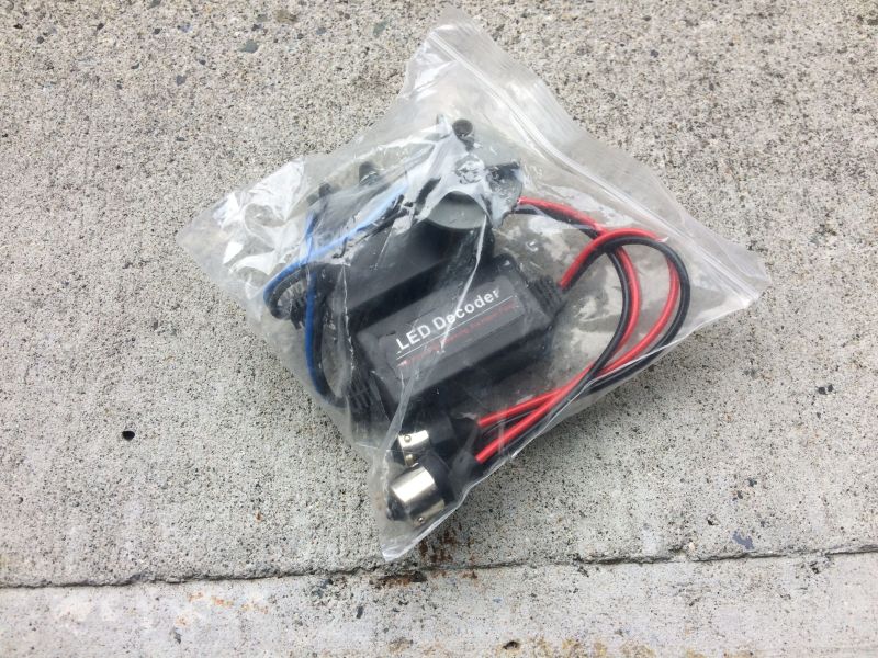 LED decoder with wires in a plastic bag on concrete