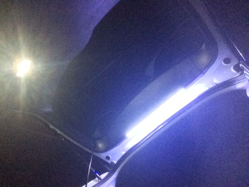 Interior of a vehicle with LED light strip and dome light.