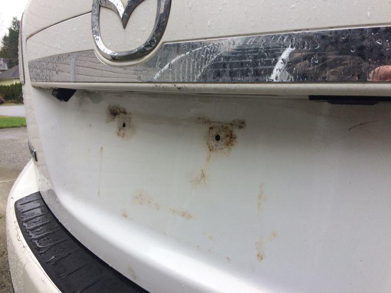 Plate removed; the damage caused by the license plate resting on the paint.