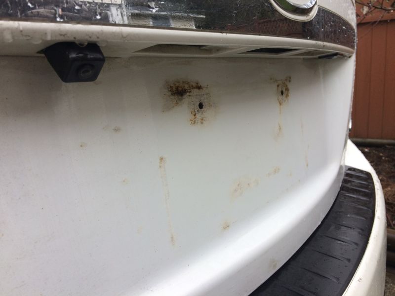 Plate removed; the damage caused by the license plate resting on the paint.
