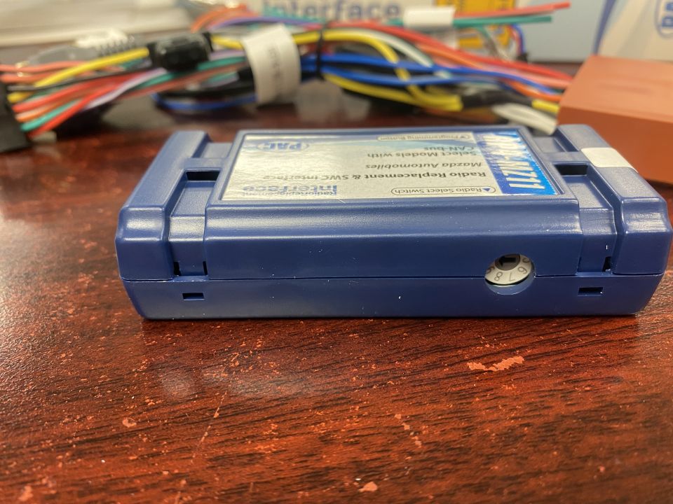Blue PAC interface module with wires in the background.