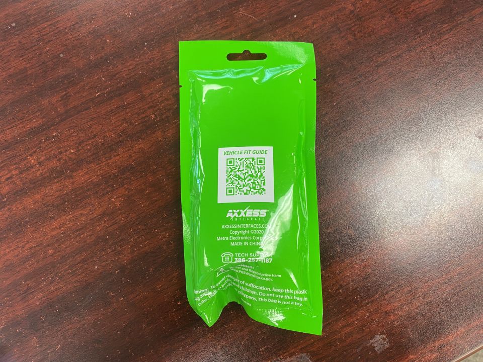 Green plastic packaging bag with AXXESS logo and QR code