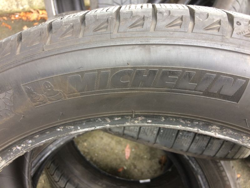 Michelin tire sidewall with brand name and Michelin Man logo