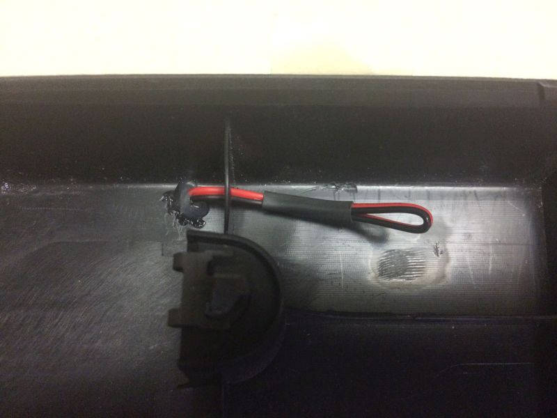 Left side. Drilled a hole in the panel and the ribbing for the wire to go through, then put some hot glue on the panel and around the wire to keep it in place. This wire doesn't need power, so I cut it, folded it back and shrink tubed it.