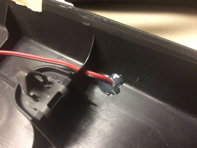 Right side. Drilled a hole in the panel and the ribbing for the wire to go through, then put some hot glue on the panel and around the wire to keep it in place.