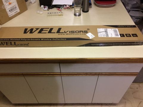 2009 Mazda CX-9 - A cardboard box for Well Visors Injection Molded Polycarbonate Window Deflectors is shown on a countertop.
