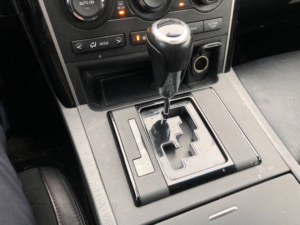 Close-up of a car's automatic transmission shifter and center console.