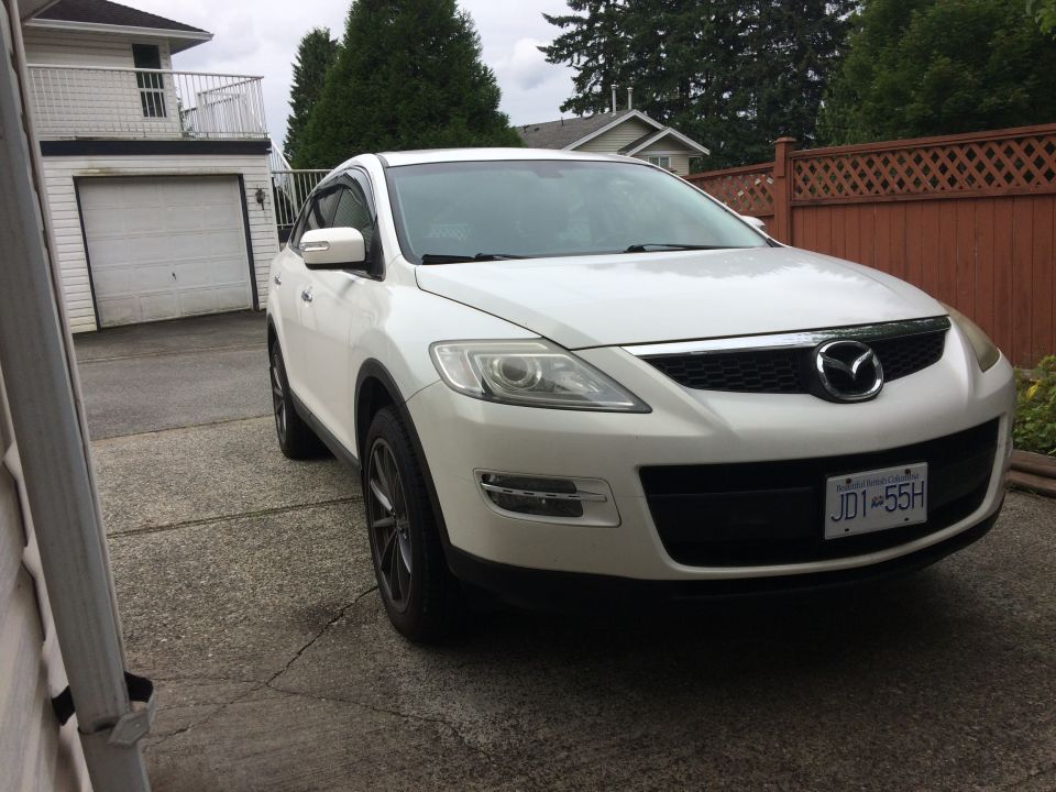 White 2009 Mazda CX-9 parked in driveway.