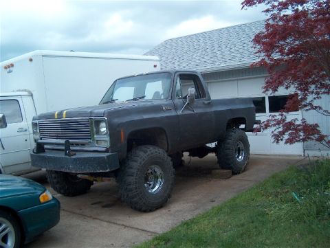 1979 Ford Bronco - This lifted pickup truck appears to be from the 1970s, not a 1979 Ford Bronco.