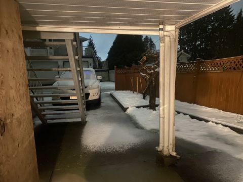 2009 Mazda CX-9 - A white 2009 Mazda CX-9 is parked in a driveway covered in a light dusting of snow. The vehicle is viewed from under a covered patio area.