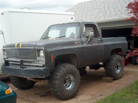 1979 Ford Bronco - This lifted pickup truck features a prominent grille and large tires, suggesting a model from the mid-1970s.