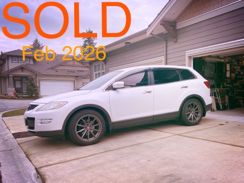 White 2009 Mazda CX-9 parked in driveway with "SOLD Feb 2026" overlay.