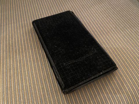 1990 Ford Thunderbird - A black velvet-covered case sits on a striped surface.