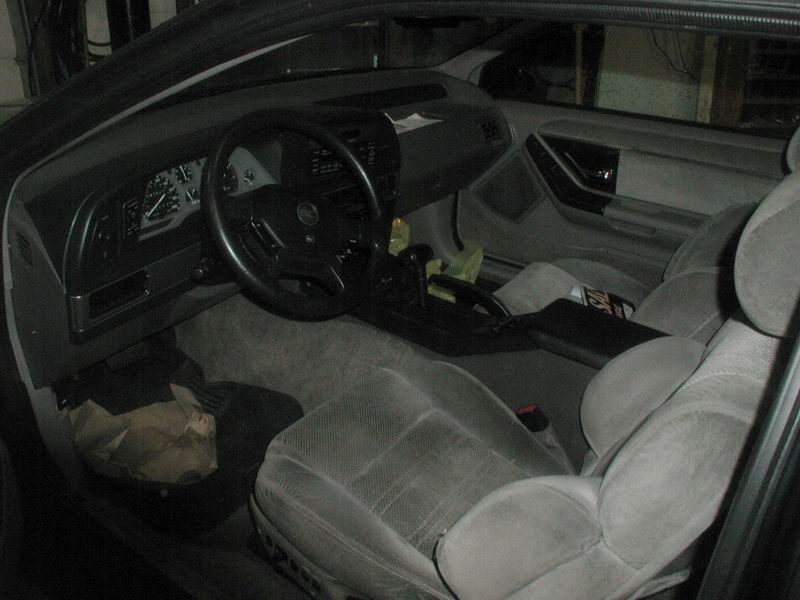 Interior of a Ford Thunderbird showing seats, dashboard, steering wheel, and center console.