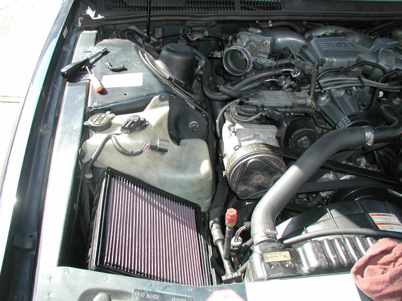 1990 Ford Thunderbird engine bay with K&N air filter and coolant reservoir
