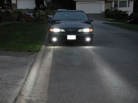 1990 Ford Thunderbird - Headlights and driving lights, camera at chest height, flash on.