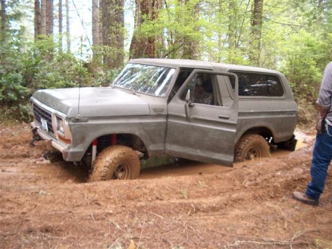 1979 Ford Bronco - This 1979 Ford Bronco is stuck deep in the mud with the driver's door ajar.