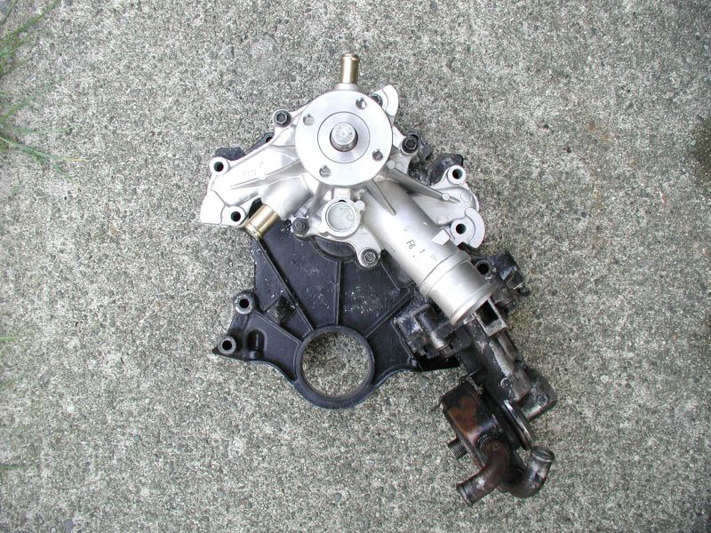 The new timing cover with a brand new water pump mounted.