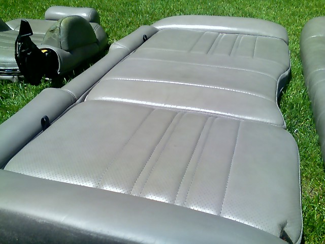 Grey leather car seat cushions on grass