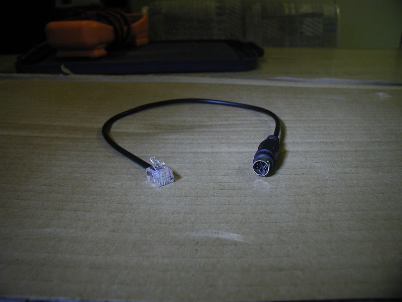 Black cable with RJ45 and 5-pin DIN connectors