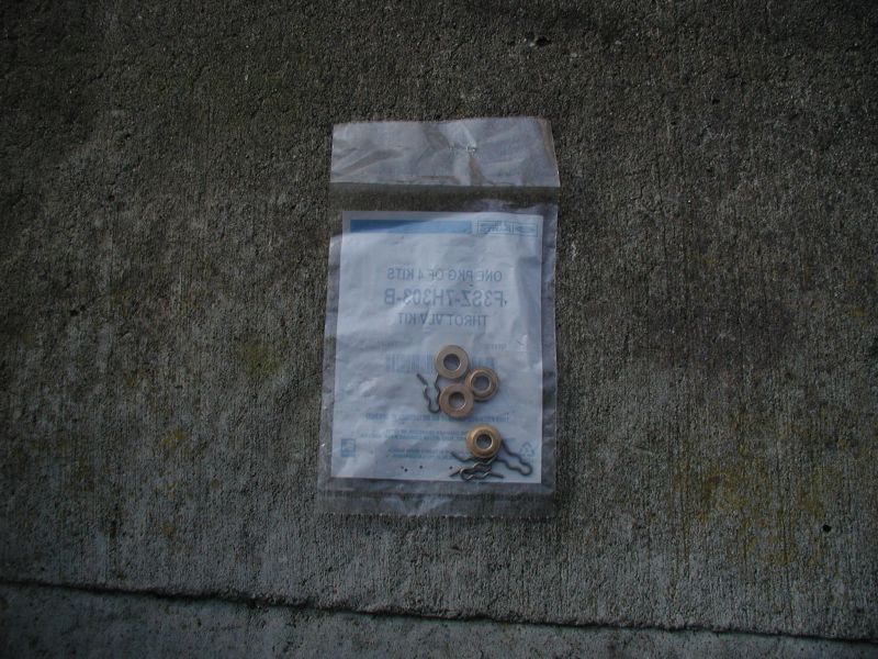 Throttle kit in a plastic bag on concrete