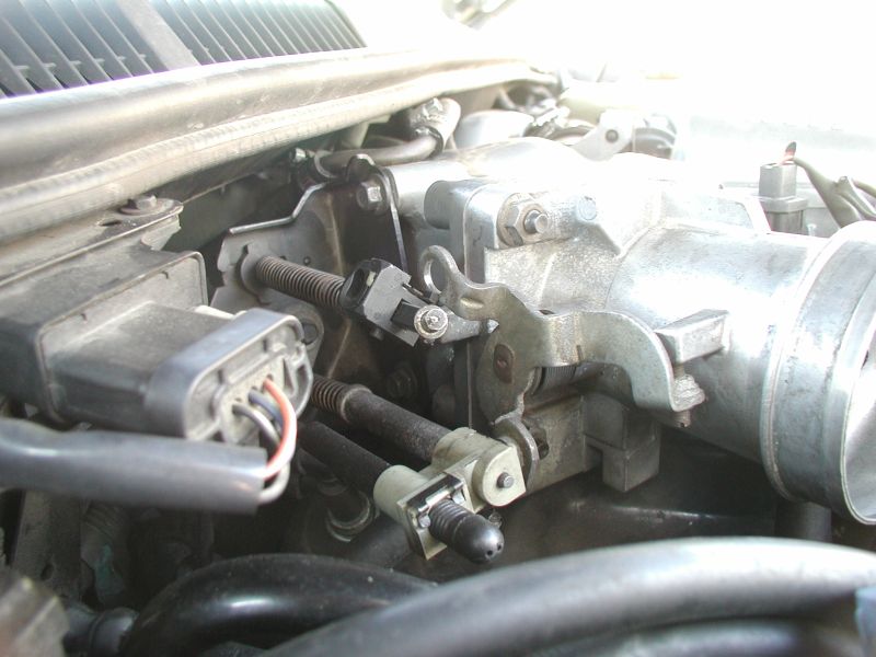 Remove the air intake tube, then disconnect the TV cable from the throttle body.