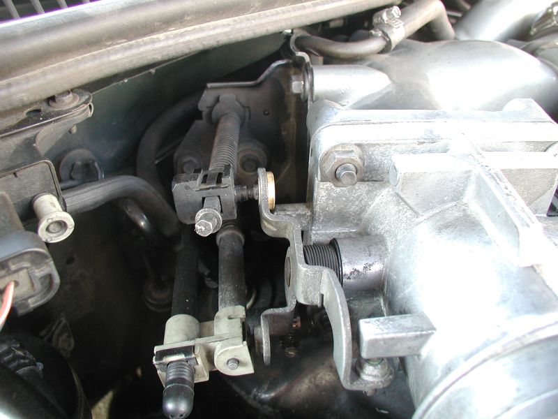 Insert the bushing into the linkage; ensure that the shoulder of the bushing is facing the throttle body.