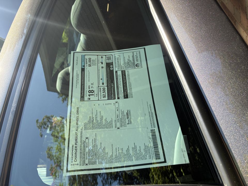 2020 Dodge Charger Pursuit AWD window sticker shown inside a car's rear side window