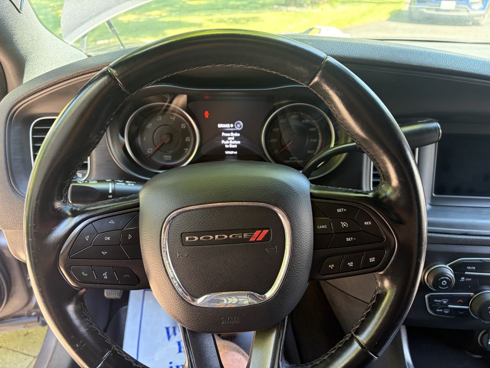 Dodge leather steering wheel with badge and control buttons, cluster showing push-start message