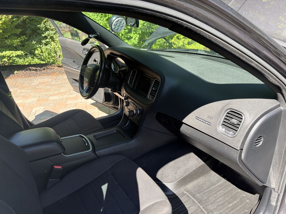 Dodge Charger dashboard and black cloth interior seen from passenger side