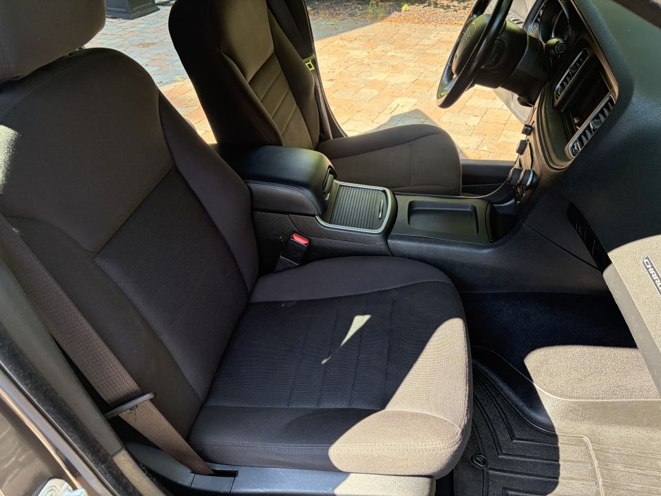 Black cloth front seats and center console in a Dodge Charger interior