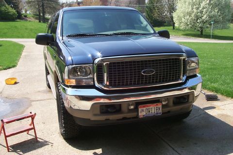 2003 Ford Excursion - A blue Ford Excursion is parked on a driveway, facing the camera.