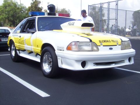 2002 Ford Mustang - This modified Ford Mustang is painted white with yellow graphics and "Glendale Police" text.