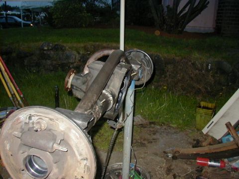 1994 Ford Explorer - A rear axle assembly with brake components is shown in an outdoor setting.