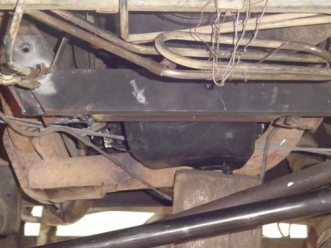 1993 Ford Bronco - Underside view of vehicle frame, exhaust pipes, and fuel tank, showing crossmember details.