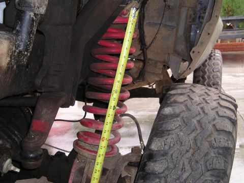 1986 Ford Bronco II - Measuring suspension components on an off-road vehicle, likely for modification or repair.