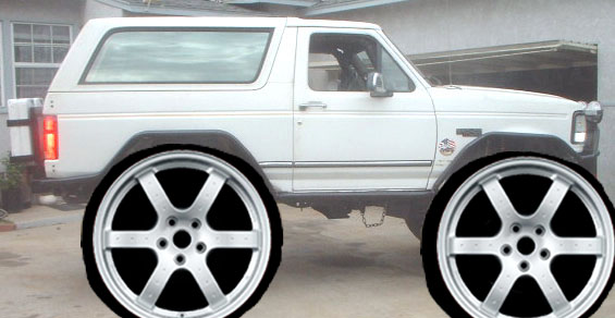 White 1980s Ford Bronco with oversized aftermarket wheels digitally added, side view