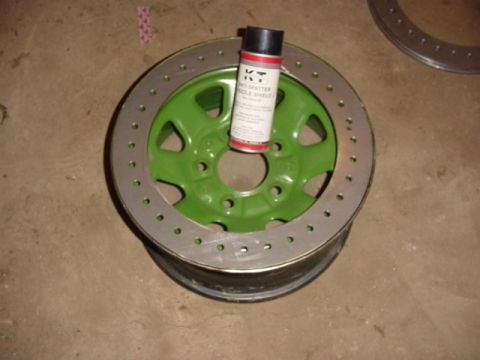 1992 Ford Bronco - A can of spray paint rests on a green wheel with a metal outer ring.