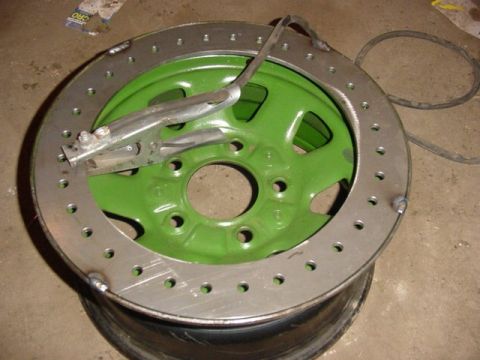 1992 Ford Bronco - A custom-made beadlock wheel is shown with a clamp attached, indicating it is a vehicle part.