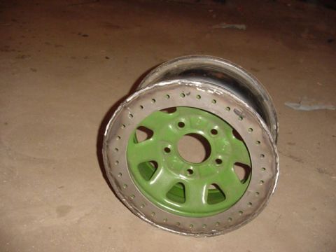 1992 Ford Bronco - A custom wheel with a green center and a modified beadlock ring is shown, likely for off-road use.