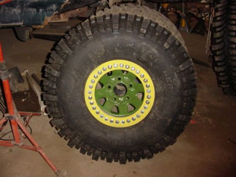 1992 Ford Bronco - Close-up of a large off-road tire and custom beadlock wheel assembly.